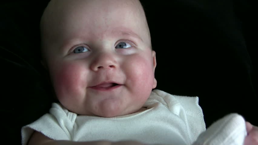 Baby playing with his feet and sock, while laughing and smiling. HD 1080i