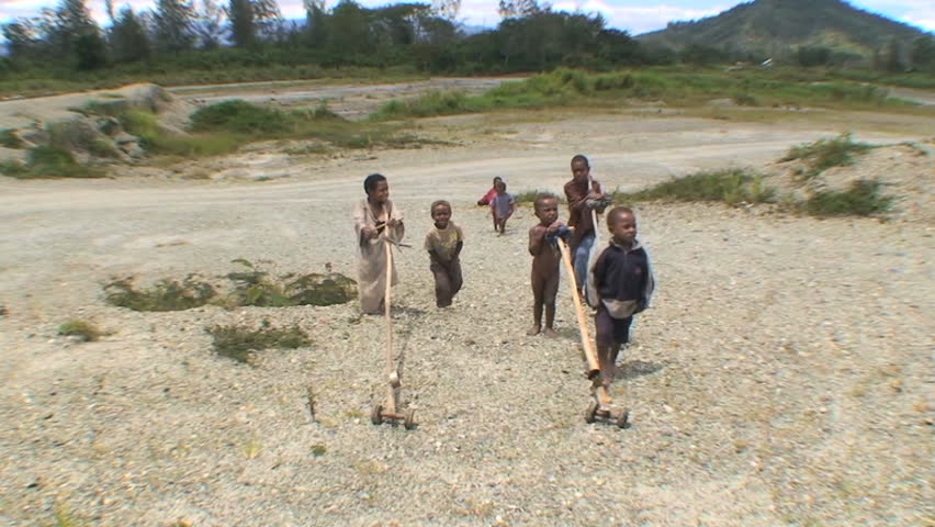PAPUA NEW GUINEA - NOV.5: Native young children playing with homemade toys, in the Mt. Hagen Highland area in Papua New Guinea, November 5, 2008.