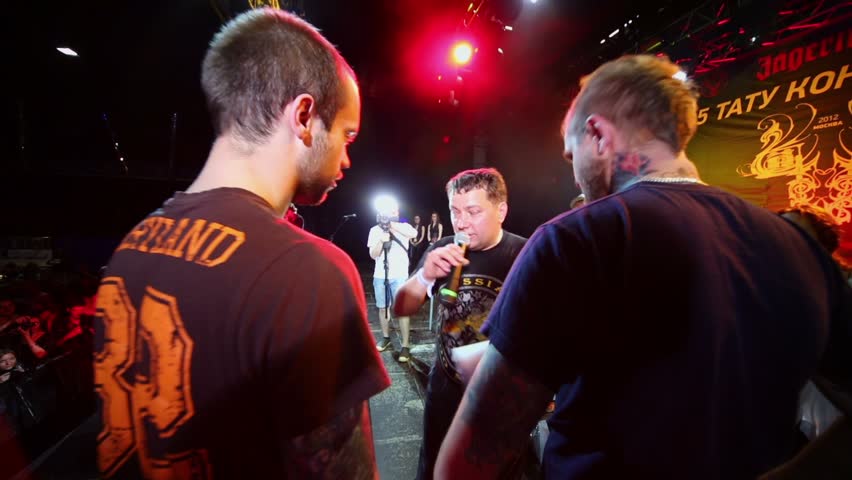 MOSCOW - MAY 20: Narrator congratulates contestant on stage of club ARENA during Moscow International Tattoo Convention V on May 20, 2012, Moscow, Russia. Event was organized by Tattoo Studio Angel.