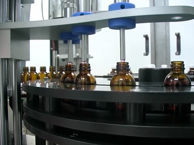 Close-up on a liquid medicine production line.