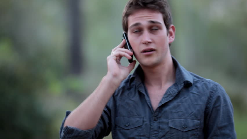 Casual young man receiving a phone call on his cell phone