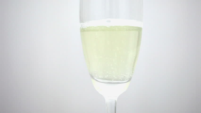 Closeup sparkling wine with bubbles in a glass