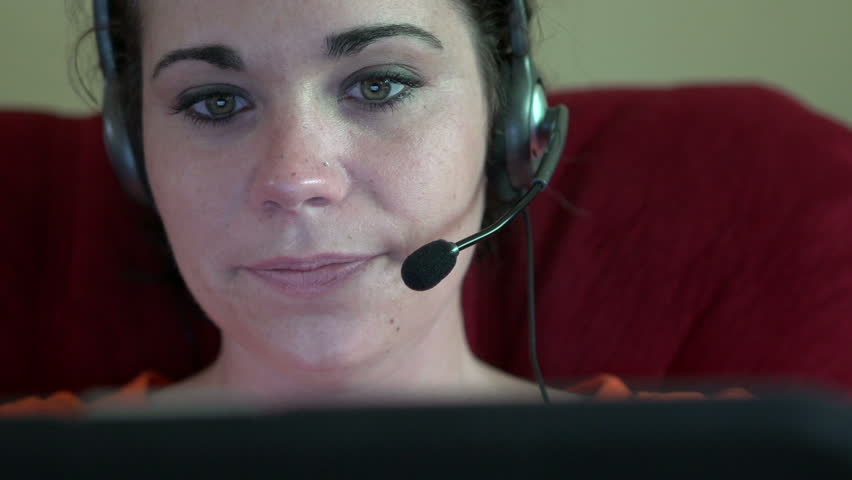 Female playing laptop games with headset on