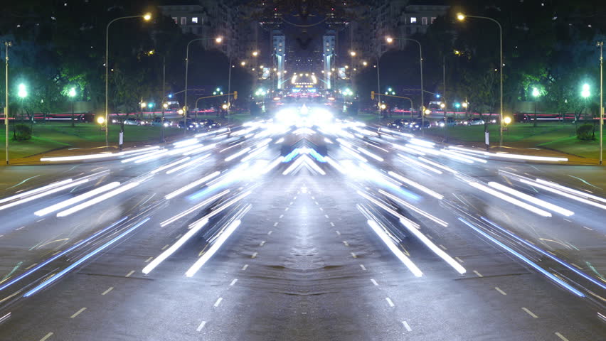 Traffic in the city. Avenue Time-Lapse, symmetric / mirrored, Night. Moon going down. Heavy traffic / jam / flowing with blurred motion.