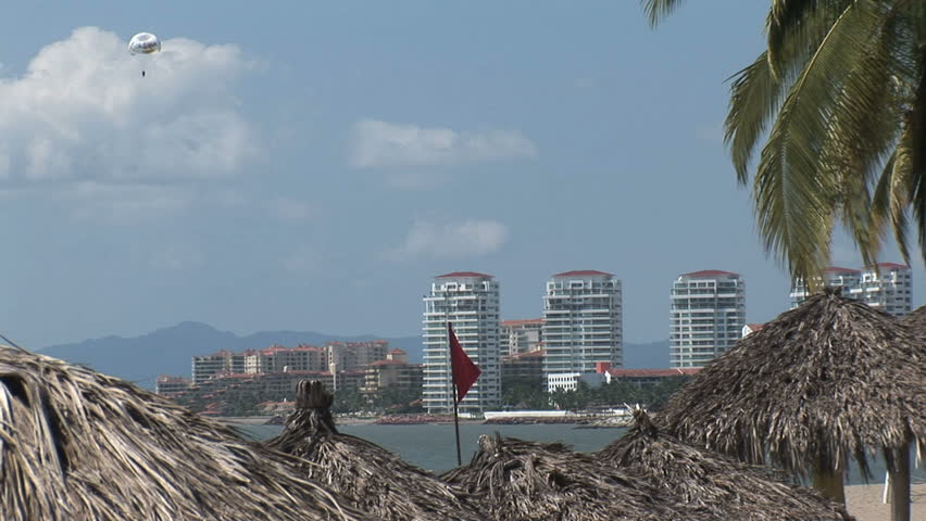 Parasailing along the coast of Puerto Vallarta, Mexico with condos in the background