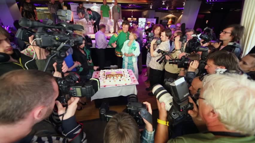 MOSCOW - JUNE 5: Stars and cameramen near cake at presentation of Lena Lenina Stars in style of ECO in restaurant MUZEY on June 5, 2012 in Moscow, Russia.