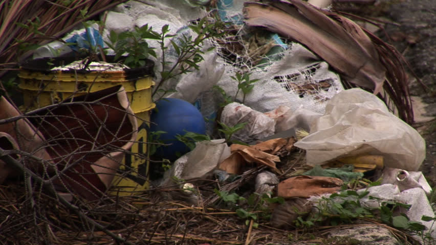 Trash in the street in Venezuela with condominiums in the Background
