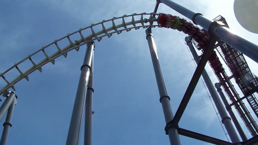 At amusement park, rollercoast.