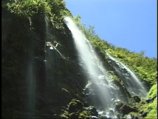 Spectacular Hawaii waterfall. The perspective is beneath the waterfall as mist sprays over the camera.
