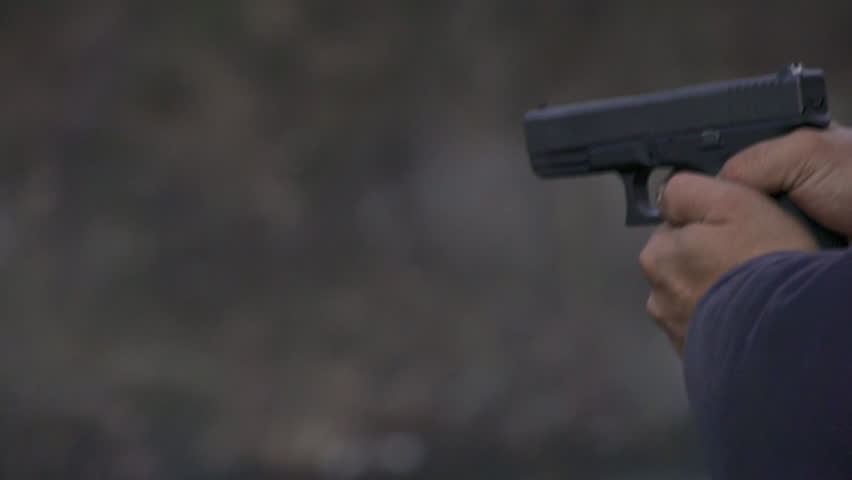 View from left of a man firing a Glock handgun repeatedly, with visible muzzle flash