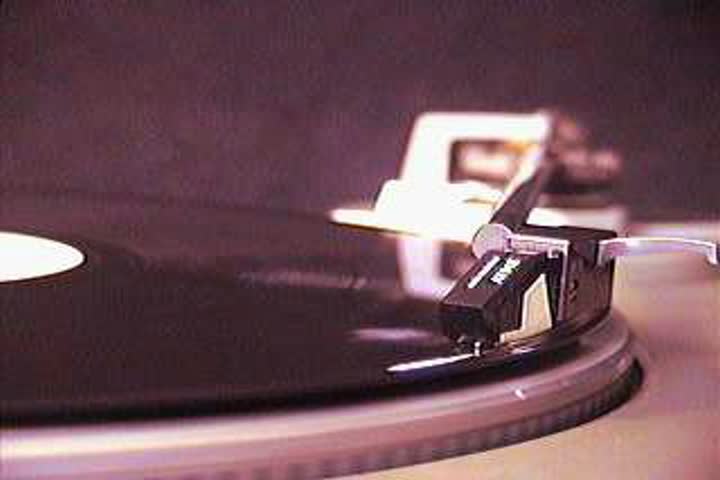 A classic turntable and 12" vinyl record.