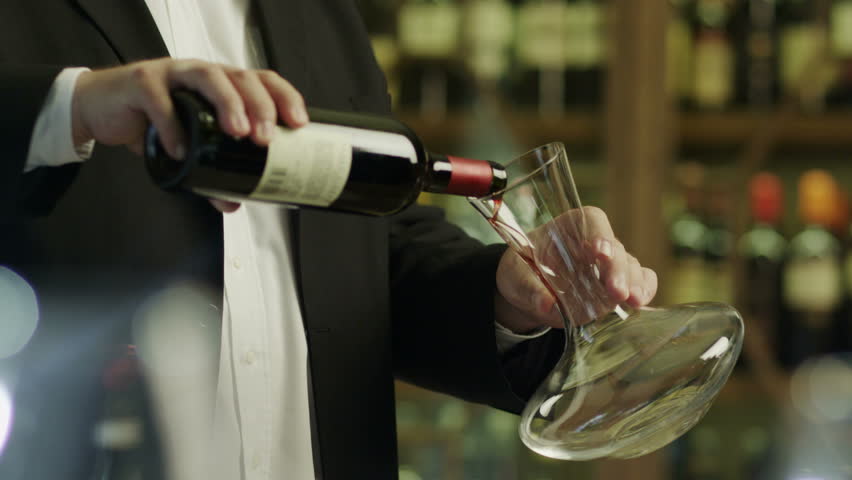 Sommelier Pouring Red Wine into Decanter. Shot on RED Digital Cinema Camera in 4K (ultra-high definition (UHD)), so you can easily crop, rotate and zoom, without losing quality!