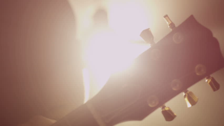 Concert rock band performing on stage with singer performer, guitar, drummer.  Music video punk, heavy metal or rock group.  Slow motion instrument playing band of men.