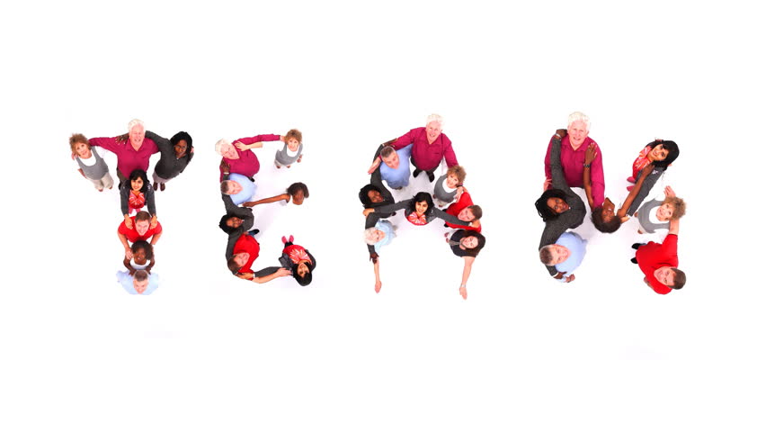 Group of various people coming together to spell the word "Team". Shot in large white studio. High quality HD video footage.