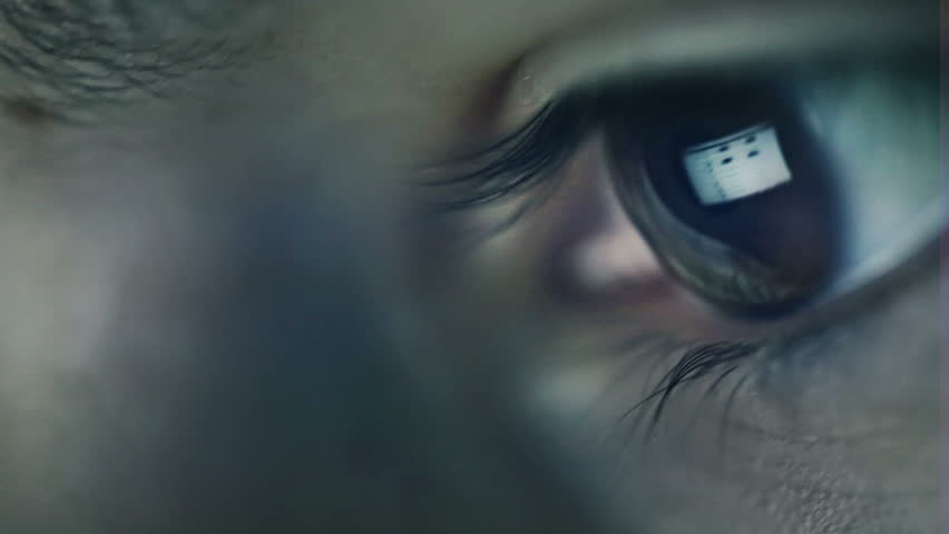 Closeup shot of boy eye surfing internet at night
