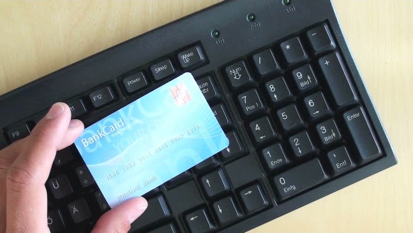 man pays online with bank card 