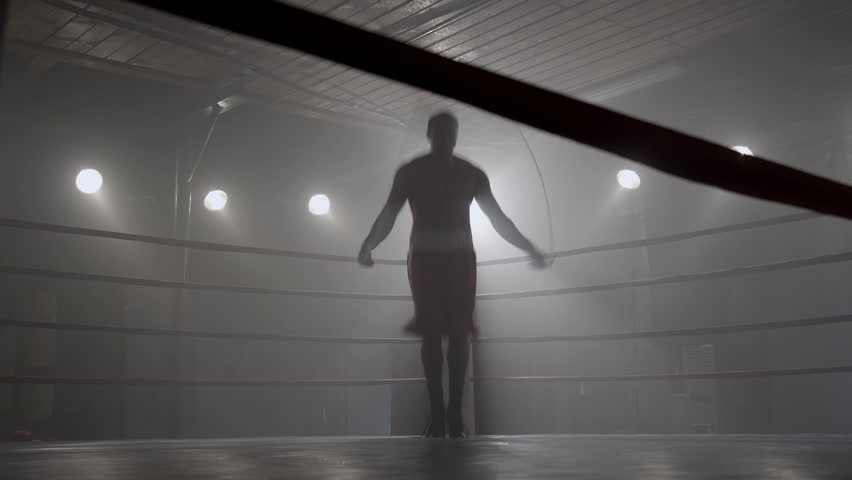 Boxer jumping rope in boxing ring
