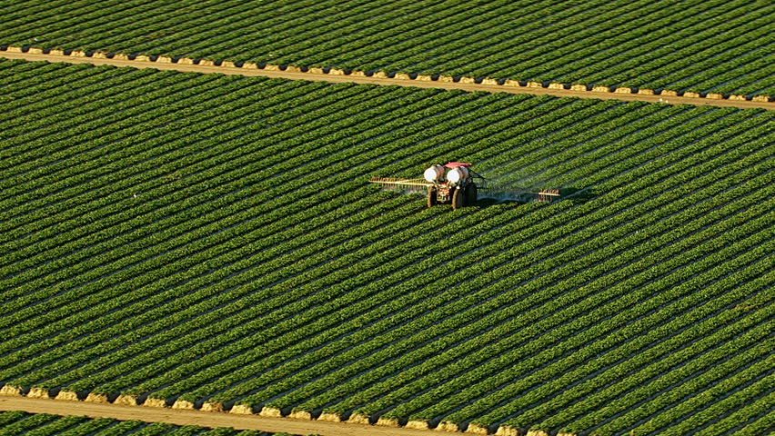 Aerial shot of tractor spraying field