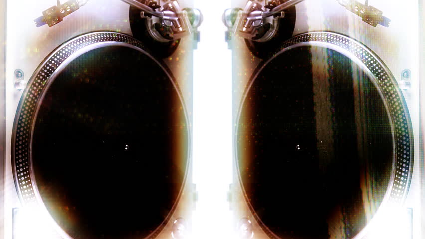a dj's hand puts a vinyl on a turntable