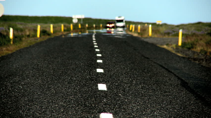 Traffic & heat reflection on a tarmac countryside road