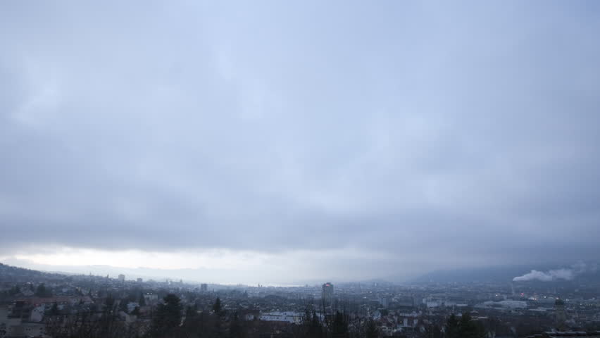 A living winter postcard: smoking chimneys, a city and a lake (time-lapse)