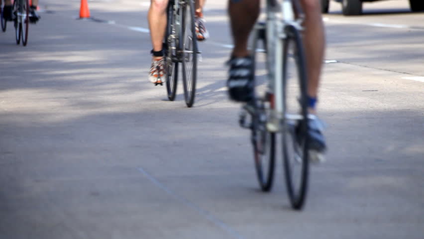 Competitive cyclists riding their bikes in the second leg of a local triathlon.