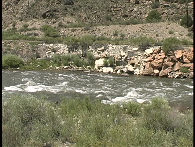 High, turbulent water moves quickly over a small set of rapids in the Arkansas River in central Colorado.