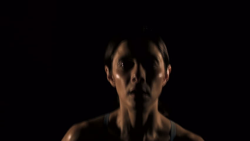 Woman jogging against black - HD