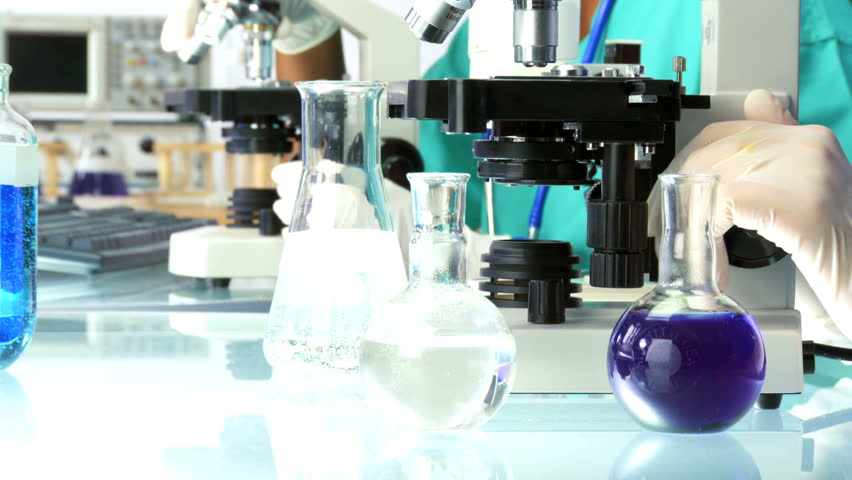 Female doctors working in lab with a  microscope