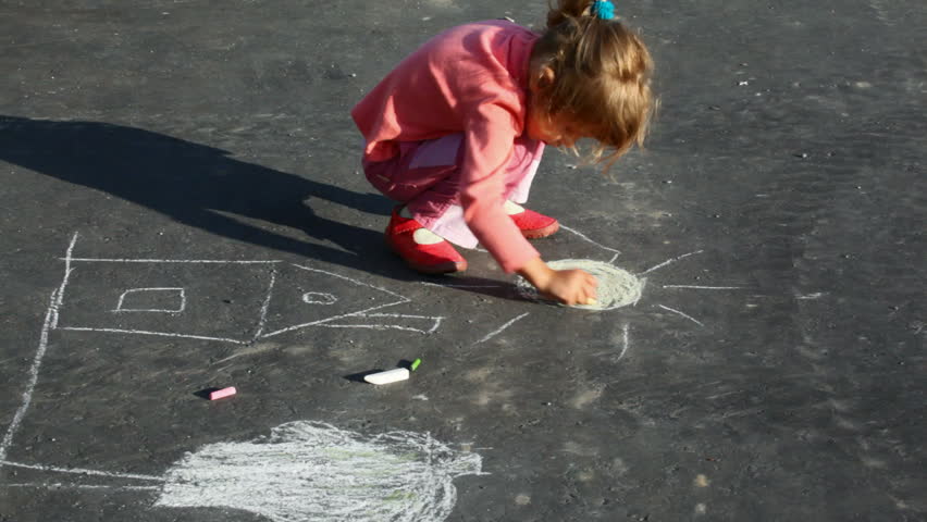little girl chalking on asphalt 