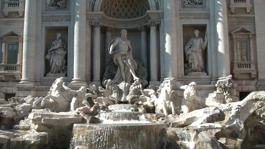 Wide shot of the famous Trevi Fountain (Fontana di Trevi) in Rome, designed by Nicola Salvi in Baroque and Rococo fashion. Legend holds that visitors should throw a coin into the fountain for luck.