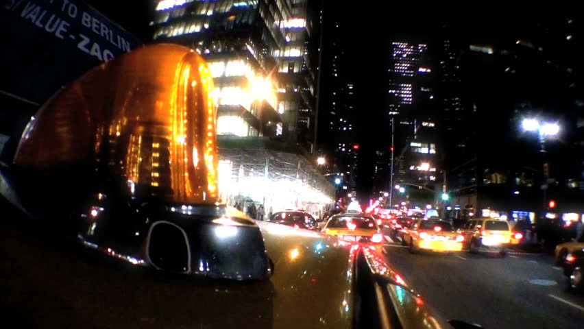 Point -of-view of yellow taxi cabs driving the streets at night in New York City, USA