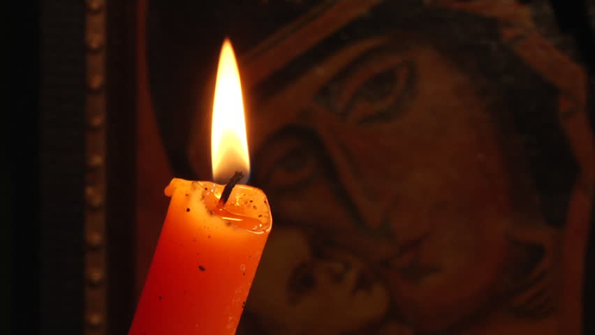 candle and Christian Orthodox icon