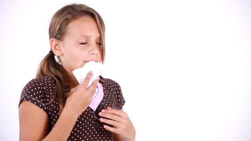 A young girl coughing and sneezing as if she is coming down with a cold or the flu. Copy Space, White Backdrop.