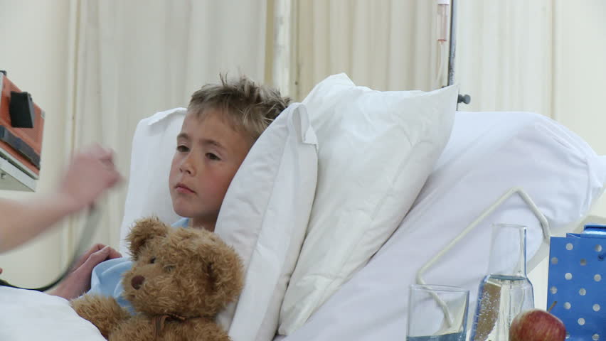 Female doctor examining a little patient recovering in bed. Footage in high definition