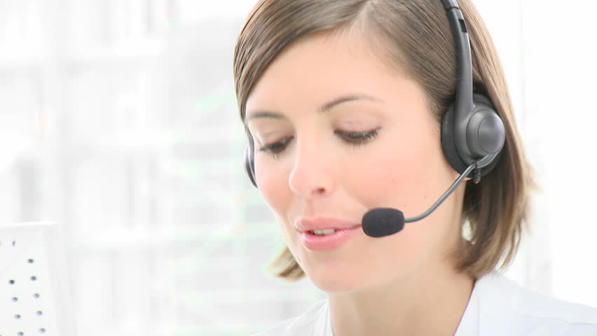 Close-up of smiling woman working in a call center. Customer service. Footage in high definition 