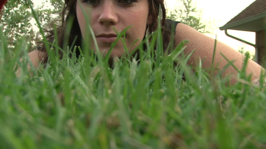Female Cutting Lawn with Scissors