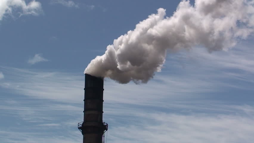 sugar mill smokestack billows white steam 
