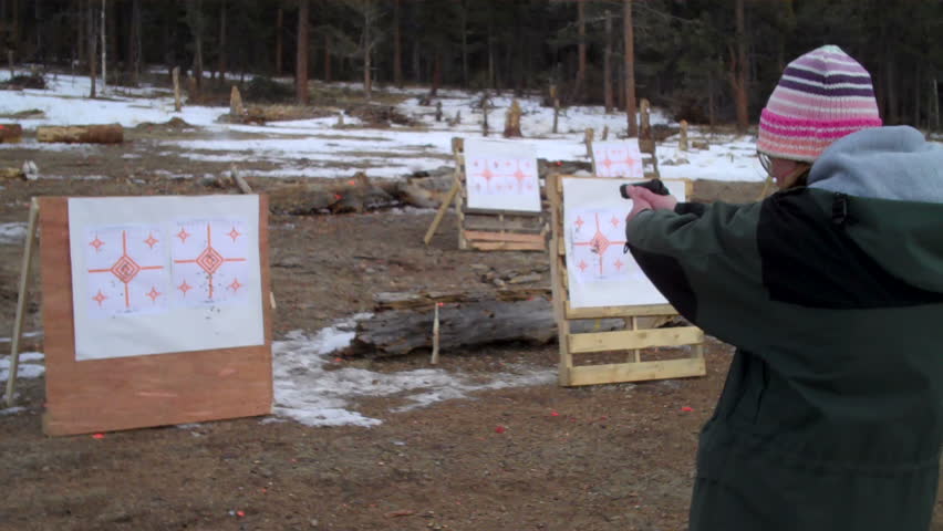young female shooting pistol