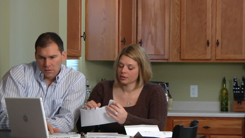 A husband and wife distressed over bills.