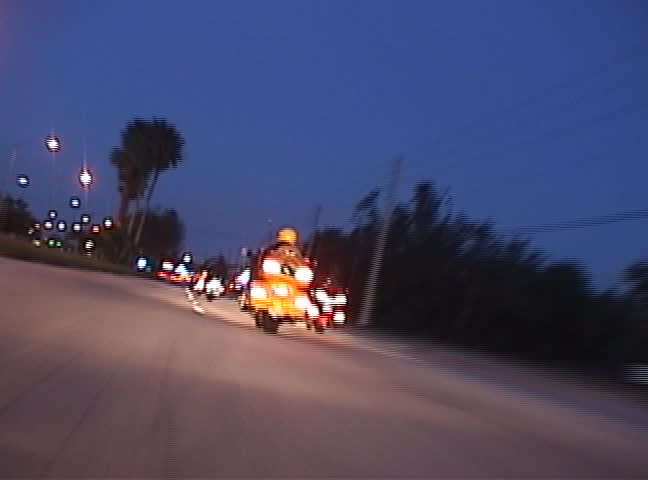 High speed clip of motorcycles at night.