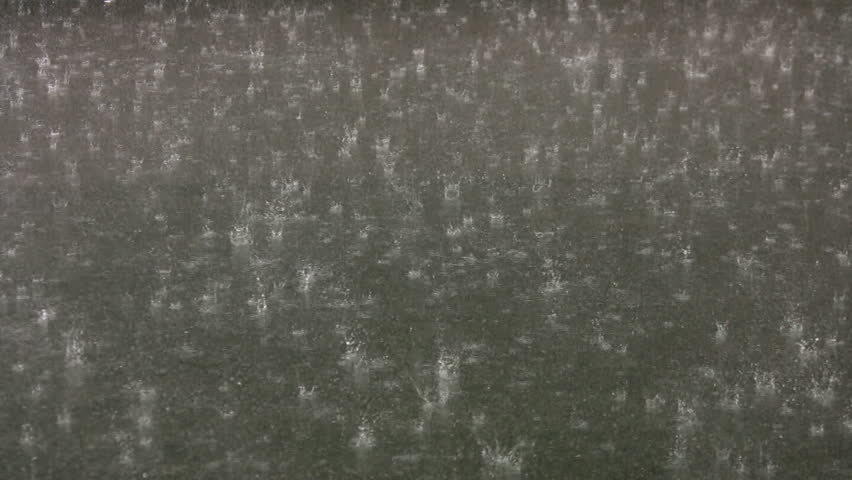 Heavy rain on asphalt. Summer thunderstorm with hard rain falling on a city street. 