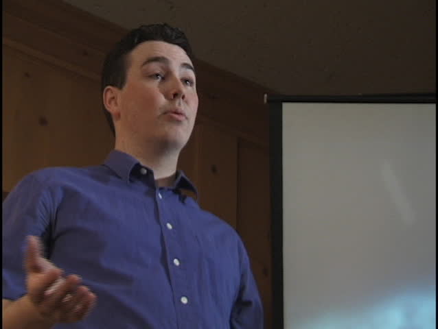 Male Teacher with Video Screen