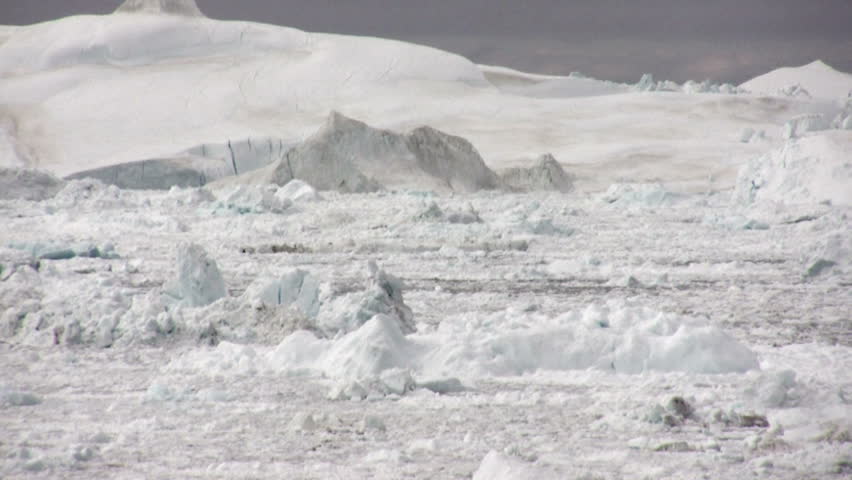An iceberg filled fjord shot from a distance and speeded up around ten times. This clearly shows the the ice passing in individual lanes.  