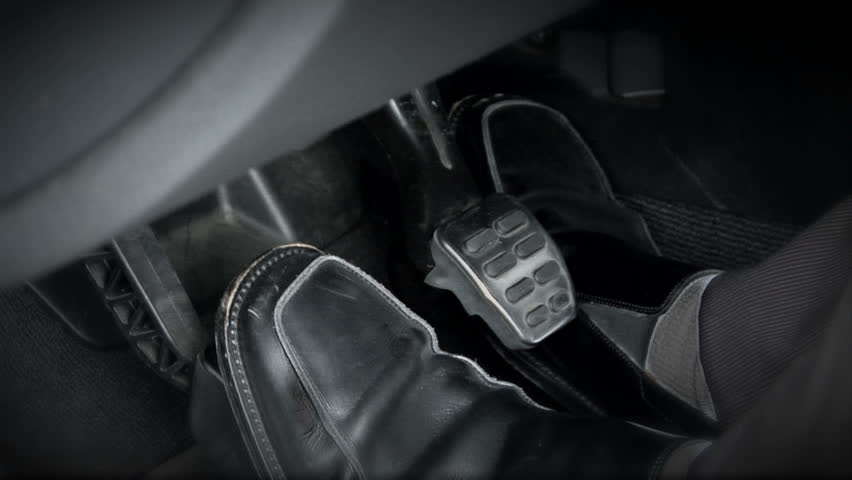 This is a shot of a sports car's pedals.  The driver changes feet quickly as he's shifting through gears.