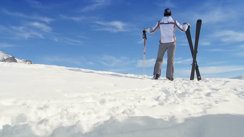 Young female skier enjoying the view while achieving her sporting ambitions
