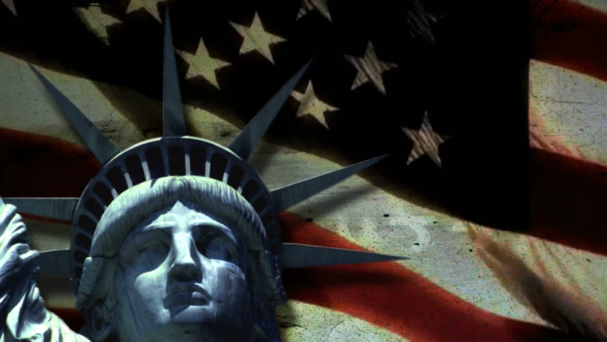 Statue of Liberty in front of waving flag.
