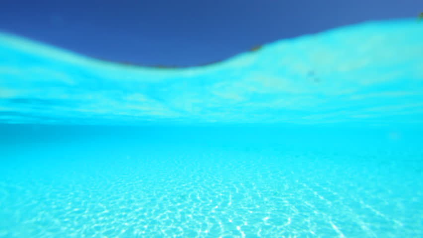 woman in bikini snorkeling in turquoise lagoon 