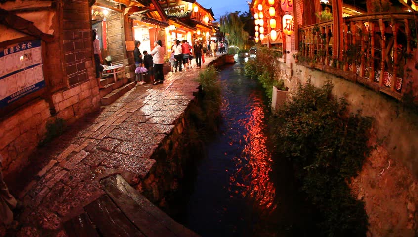 Lijiang, China - August 20: In the peak of the season, Chinese and world travelers enjoy  old town Lijiang including old architecture, restaurants and the local river in Yunnan, August 20, 2009