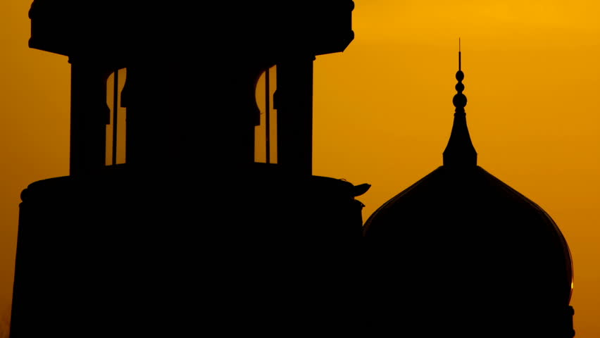 Silhouette of mosque, moving from bottom building to top.